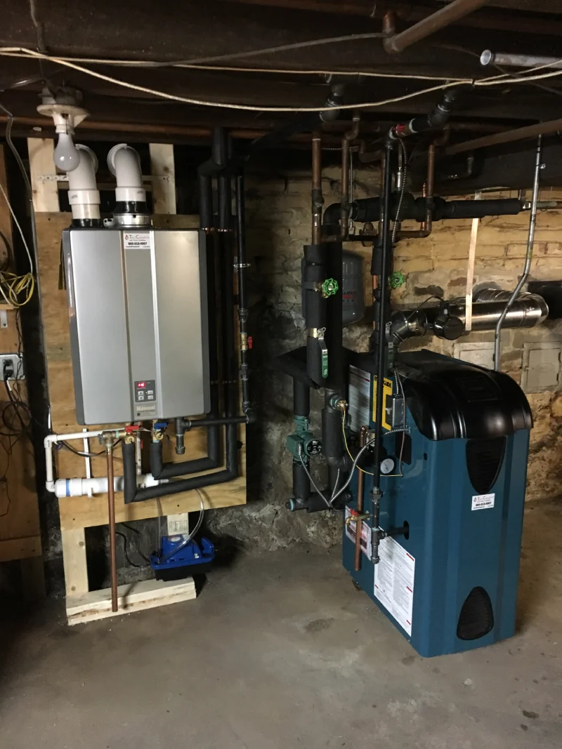 A room equipped with a water heater, furnace, and other machinery, showcasing a functional utility space.